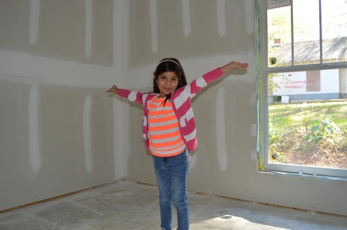 Natalie Servando shows off the interior of her future bedroom during her home's construction. 