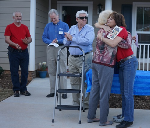 Habitat Spartanburg Construction Coordinator Peggy Magarahan and new Habitat Homeowner Nancy Tafuri hug during the Home Dedication Ceremony. 